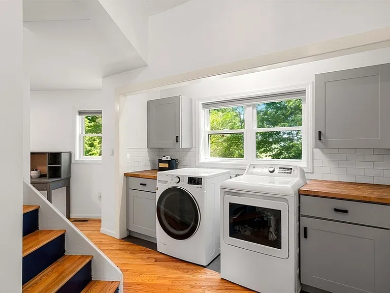 First-floor laundry room with butcher block counters and subway tile